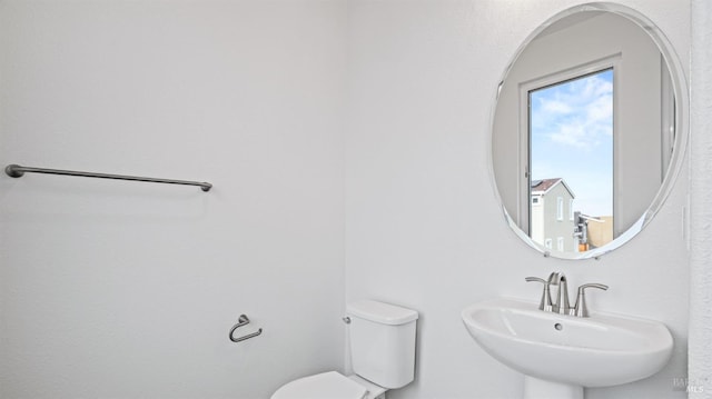 bathroom featuring sink and toilet