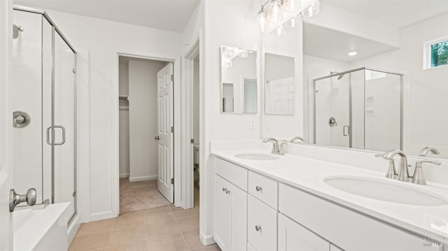 bathroom featuring walk in shower, tile patterned floors, toilet, and vanity