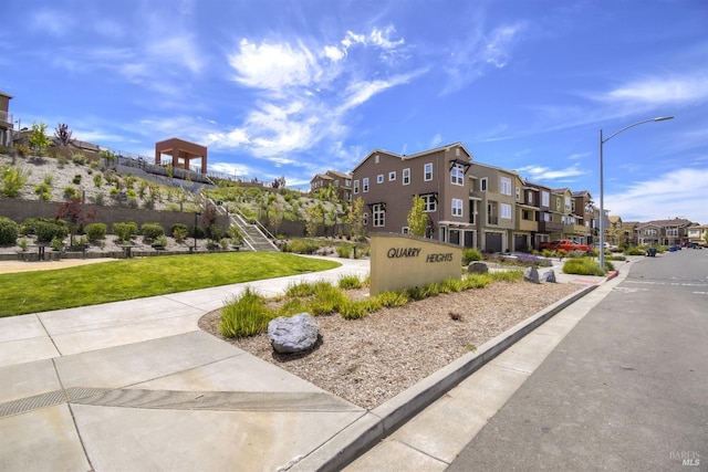 view of home's community with a lawn