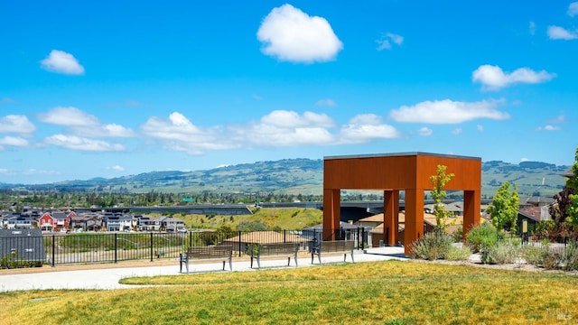 surrounding community featuring a yard and a mountain view