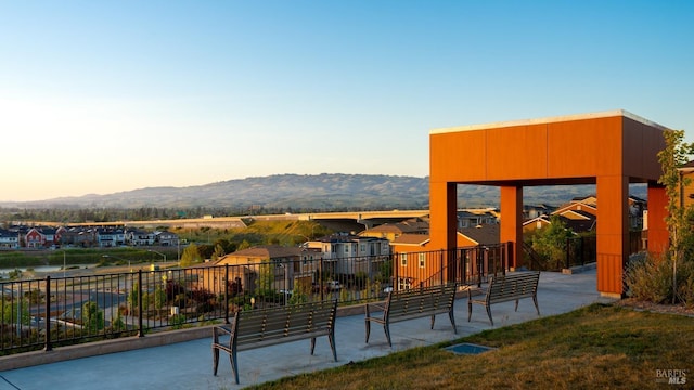 view of property's community with a mountain view and a yard