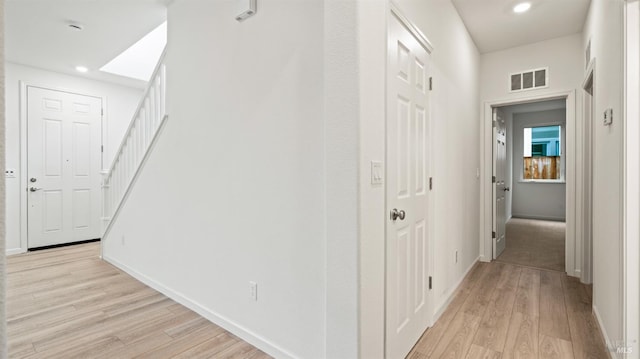 corridor with light hardwood / wood-style flooring