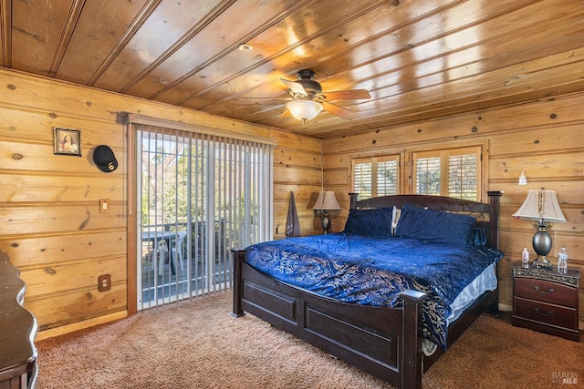 bedroom with access to exterior, carpet floors, wooden ceiling, and wooden walls