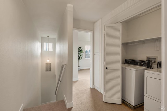 laundry area with light colored carpet, separate washer and dryer, visible vents, and laundry area