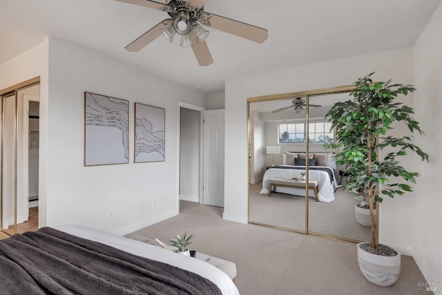 carpeted bedroom with a closet, baseboards, and a ceiling fan