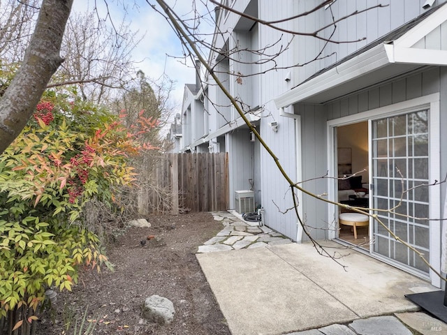 view of patio with fence and central AC