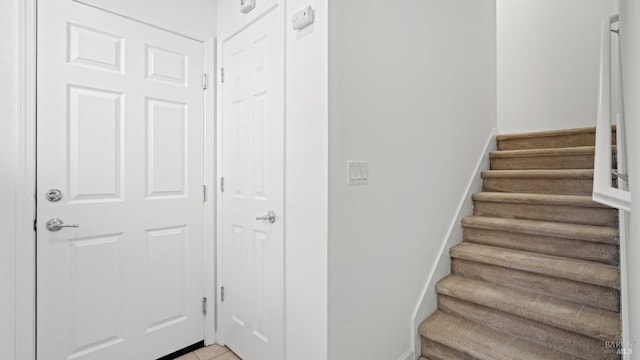 staircase featuring tile patterned floors