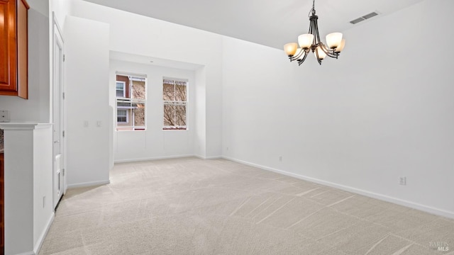 unfurnished dining area with light colored carpet and a chandelier