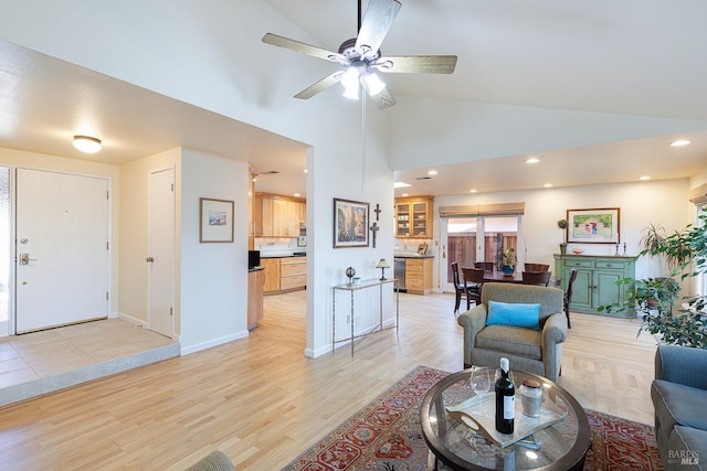 living area featuring ceiling fan, high vaulted ceiling, recessed lighting, baseboards, and light wood finished floors