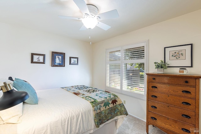 bedroom with a ceiling fan, light colored carpet, and baseboards