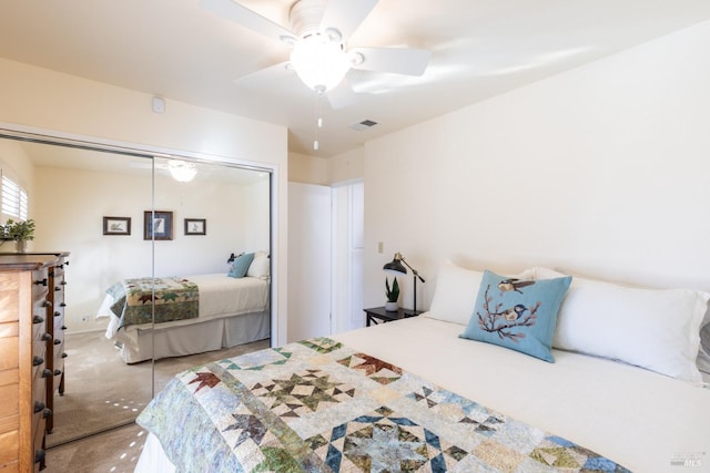 bedroom featuring carpet floors, a ceiling fan, visible vents, and a closet