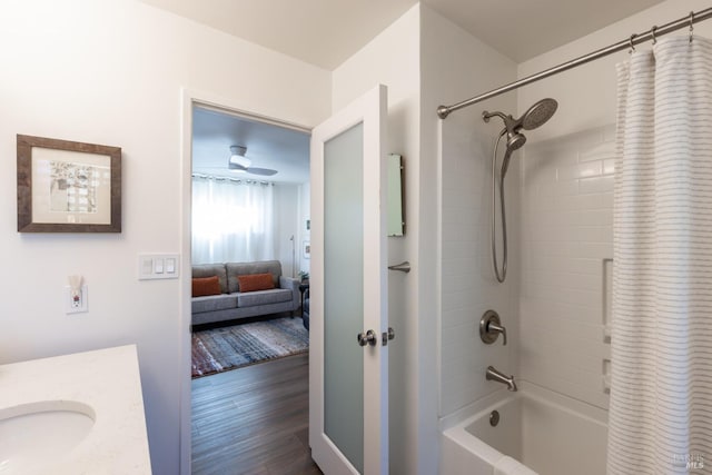 full bath featuring vanity, shower / bathtub combination with curtain, ensuite bathroom, and wood finished floors