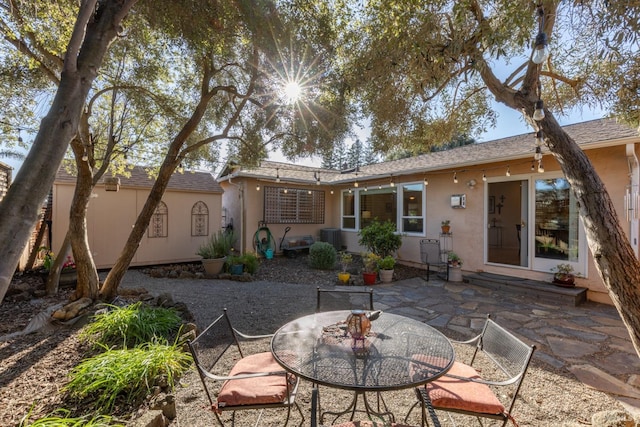 back of property featuring entry steps, a patio, central AC unit, and stucco siding