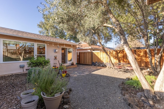 ranch-style home with stucco siding, fence, and a patio