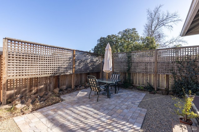 view of patio featuring fence and outdoor dining space