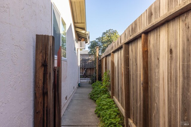 view of property exterior with fence and stucco siding