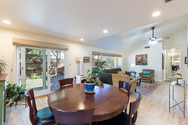 dining room featuring lofted ceiling, light wood-style floors, visible vents, and a healthy amount of sunlight