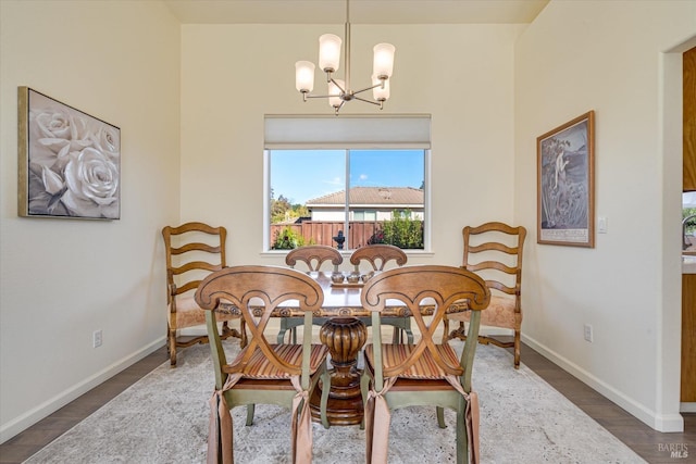 dining room featuring dark hardwood / wood-style floors and an inviting chandelier