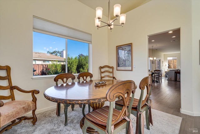 dining room with an inviting chandelier and dark hardwood / wood-style floors