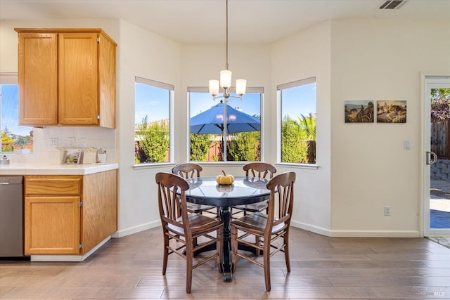 dining area featuring hardwood / wood-style flooring and an inviting chandelier