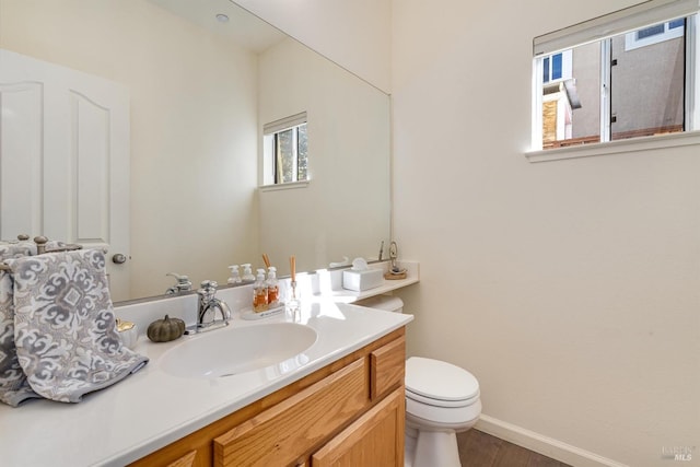 bathroom with vanity, wood-type flooring, and toilet