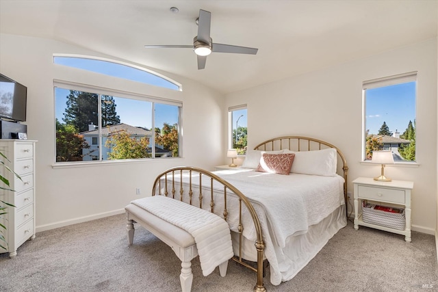 carpeted bedroom featuring lofted ceiling and ceiling fan