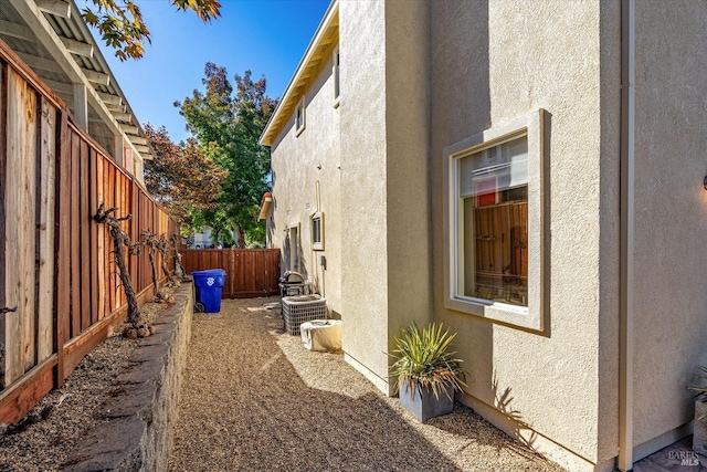 view of side of property featuring central air condition unit