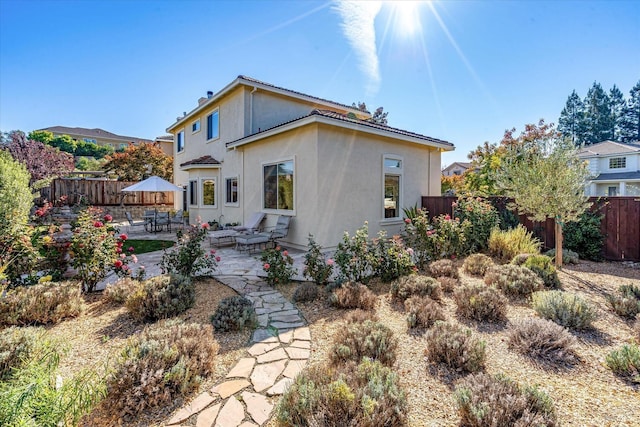 rear view of property featuring a patio area