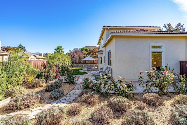 view of property exterior with a patio area