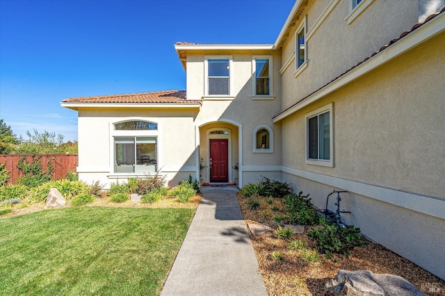 property entrance with a yard