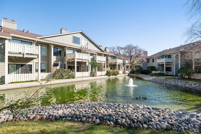 view of home's community with a water view