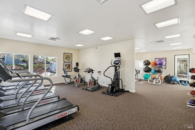 workout area with a textured ceiling