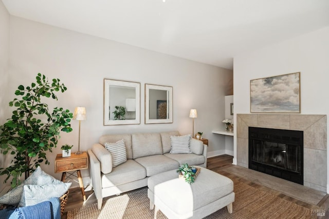 living room with hardwood / wood-style floors and a tile fireplace