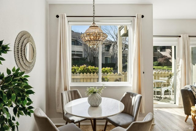 dining area featuring a notable chandelier and light hardwood / wood-style floors