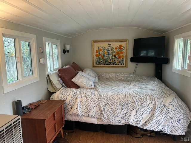 bedroom with vaulted ceiling, hardwood / wood-style floors, and wood ceiling