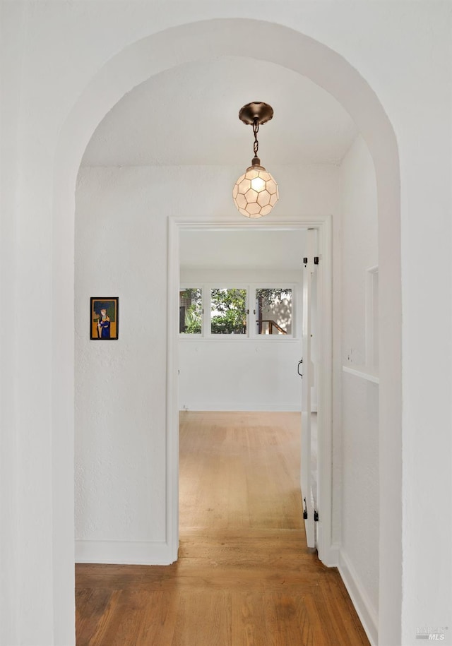 corridor with hardwood / wood-style floors