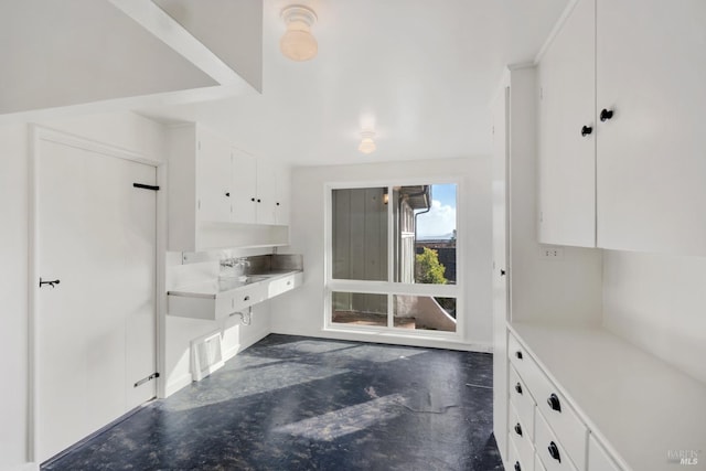 kitchen featuring white cabinetry and sink