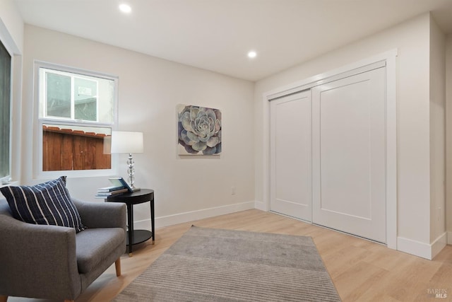 living area with light hardwood / wood-style flooring