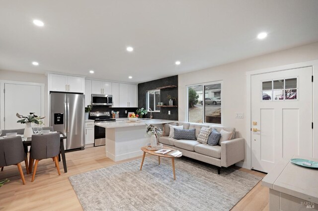 kitchen featuring light stone countertops, appliances with stainless steel finishes, sink, and white cabinets