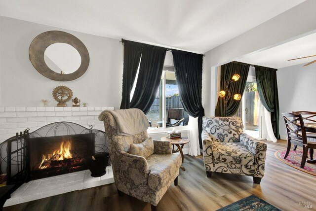 living room featuring ceiling fan and hardwood / wood-style floors