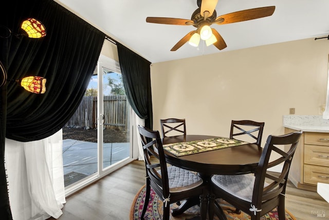 dining room with wood-type flooring and ceiling fan