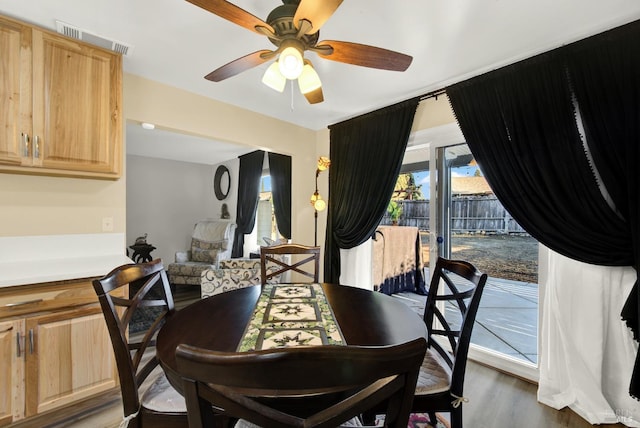 dining room with dark hardwood / wood-style floors and ceiling fan