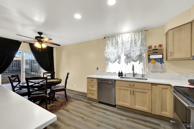 kitchen with stainless steel appliances, wood-type flooring, sink, and light brown cabinets