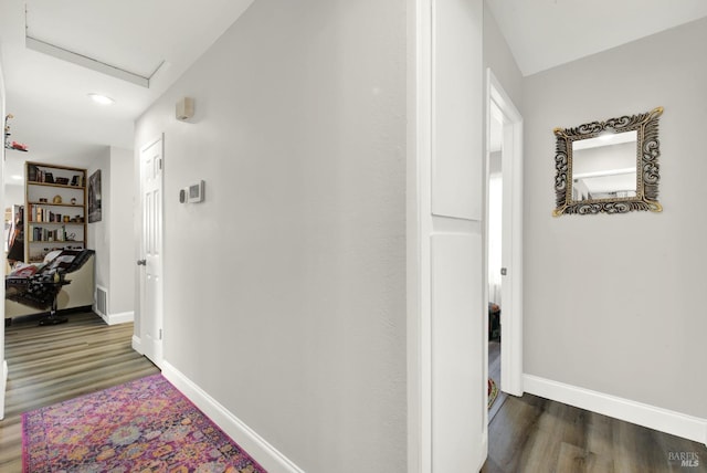 corridor with dark hardwood / wood-style floors