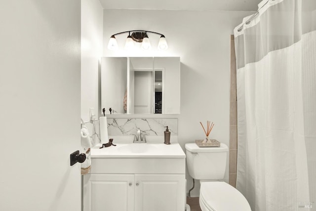 bathroom with vanity, backsplash, and toilet