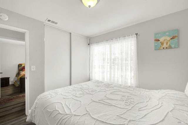 bedroom featuring hardwood / wood-style floors and a closet