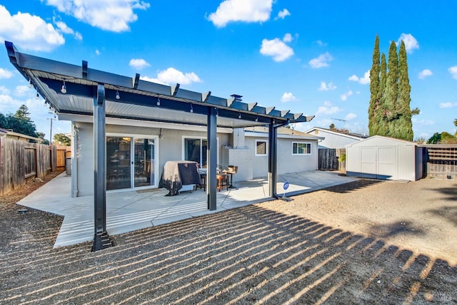 back of property with a patio and a storage unit