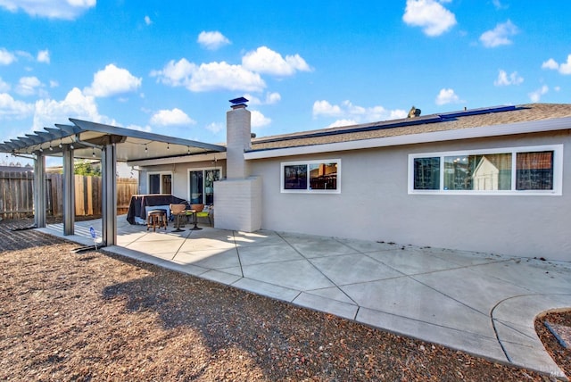 rear view of house with a patio and a pergola