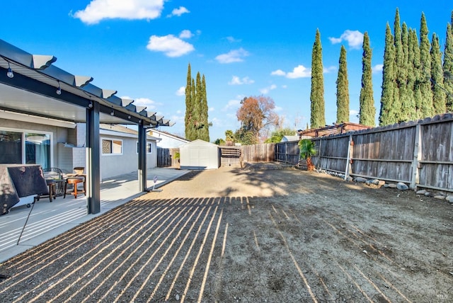 wooden terrace with a patio and a storage unit