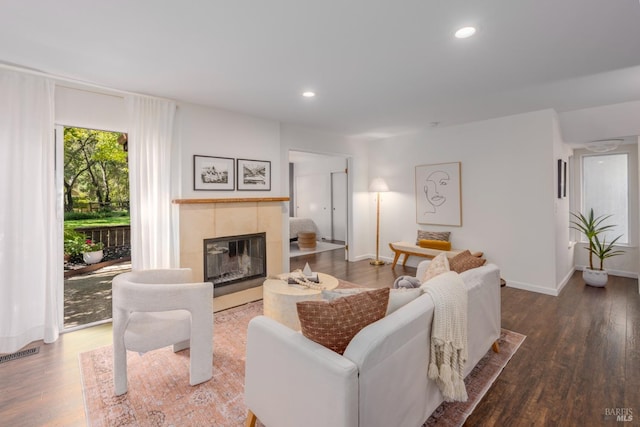 living room featuring hardwood / wood-style flooring and a tile fireplace